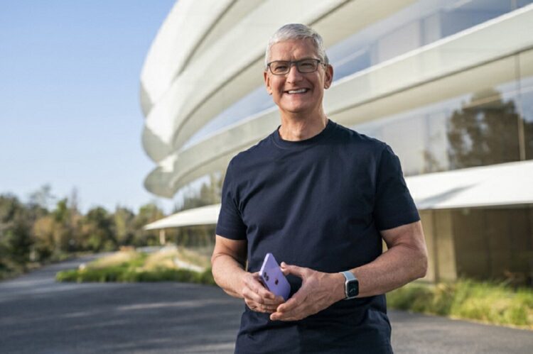 This handout released and taken on April 20, 2021 by Apple inc. shows Apple CEO Tim Cook holding a new purple iPhone 12 during a special event at Apple Park in Cupertino, California. - Apple on Tuesday unveiled a new lineup of powered-up iPads including some with 5G connectivity, responding to surging interest in tablets and home-based work and play during the pandemic. (Photo by Handout / Apple Inc. / AFP) / RESTRICTED TO EDITORIAL USE - MANDATORY CREDIT "AFP PHOTO /Apple Inc. " - NO MARKETING - NO ADVERTISING CAMPAIGNS - DISTRIBUTED AS A SERVICE TO CLIENTS